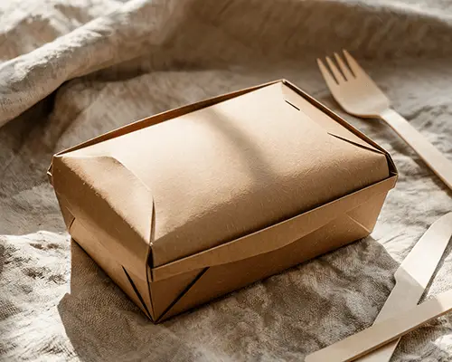 Sunlit Kraft Takeout Box Sticker Mockup On Textured Fabric Surface With Wooden Cutlery Minimal And Eco Friendly Aesthetic 0128