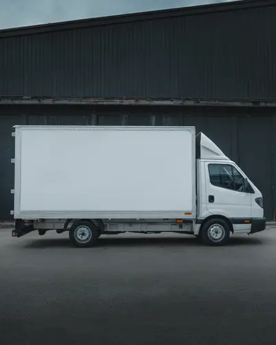 White Delivery Truck Sticker Mockup With Side Panel Display In Industrial Setting On Clear Asphalt 0184