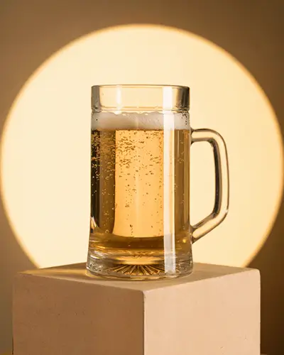 Clear Glass Beer Mug Sticker Mockup On Cardboard Podium With Glowing Warm Circle Light Background 0207