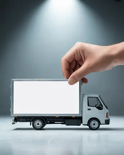 Hand Placing Sticker On Miniature Delivery Truck Mockup In Studio Lighting For Branding Display 0208