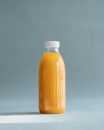 Healthy Drink Sticker Mockup On Clear Beverage Bottle Filled With Juice On Muted Studio Surface 0234