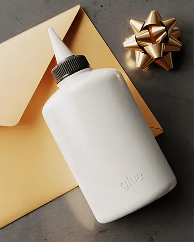Angled Glue Bottle Sticker Mockup With Envelope And Gift Bow On Minimal Desk Surface