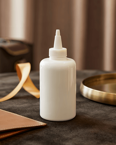 Cozy Interior Sticker Mockup On Glue Bottle With Warm Lighting And Soft Textile Desk Surface 0264