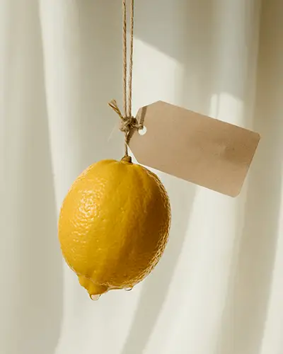 Sunlit Hanging Lemon Sticker Mockup With Brown Tag Label On String In Soft Curtain Background 0287