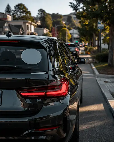 Realistic Car Sticker Mockup On Back Glass In Residential Neighborhood During Evening
