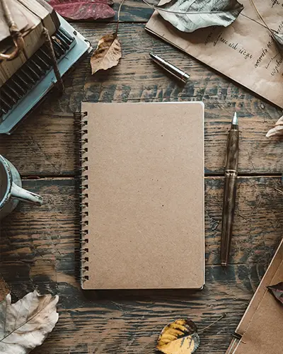 notebook-front-cover-sticker-mockup-with-wooden-surface-in-aesthetic-autumn-vibe