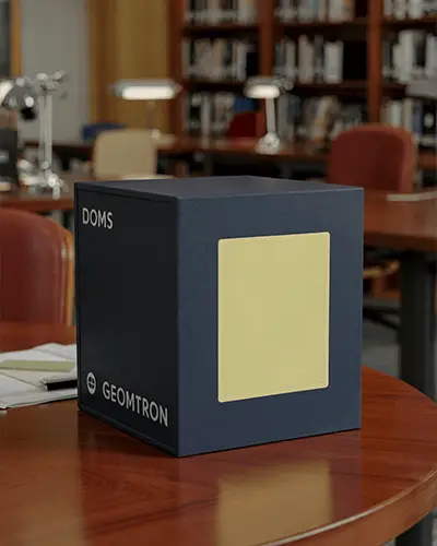 Square Sticker Mockup On Simple Cube Box Placed On Wooden Library Table Setting