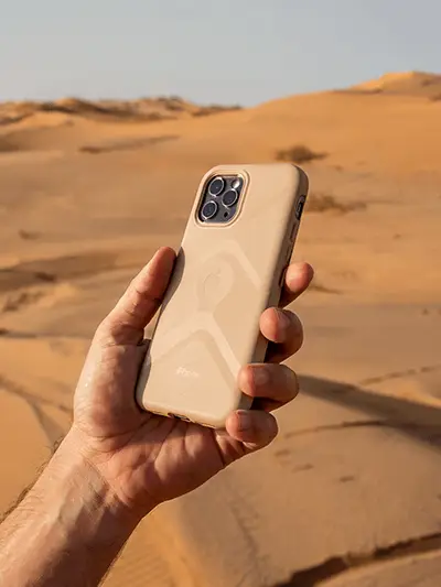 desert-adventure-phone-case-mockup-showing-hand-holding-device-in-sandy-landscape