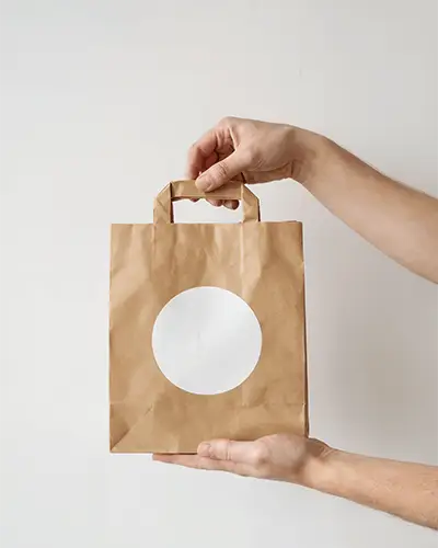 Kraft Paper Bag With Round Sticker Mockup Hands Holding Minimalist Packaging