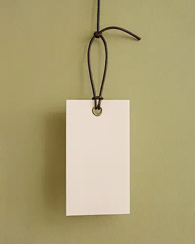 Blank Hanging Tag With String On Textured Background For Branding And Packaging Mockup