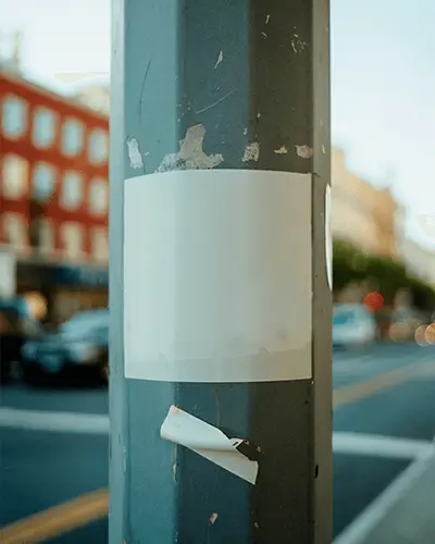 blank-sticker-on-weathered-metal-pole-urban-street-background-city-life