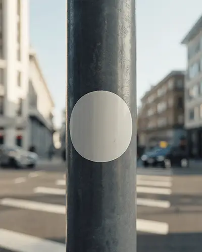Round Sticker Mockup On Outdoor Pole With City Street And Building Background