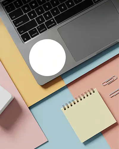 Blank Circle Sticker Mockup On Modern Laptop With Office Supplies On Colorful Background