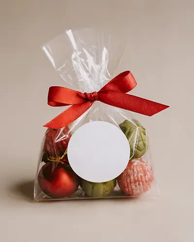 Circular Sticker Mockup On Transparent Bag With Decorative Ribbon For Custom Labels