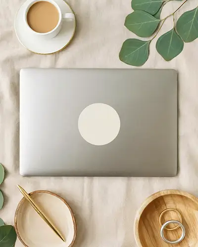 Minimalistic Round Laptop Sticker Mockup On Neutral Fabric Backdrop With Accessories