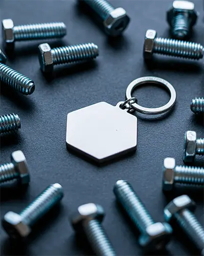 Blank Hexagon Metal Sticker Mockup Surrounded By Industrial Machine Bolts On Dark Surface