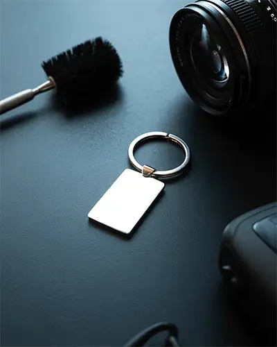 Blank Rectangular Metal Sticker Mockup On Dark Textured Surface With Photography Equipment