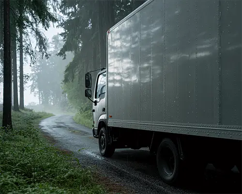 Large Commercial Truck In Forest On Rainy Winding Road Delivery Sticker Mockup