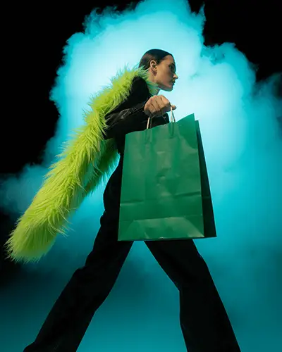 Sticker Mockups Fashion Model Walking With Green Shopping Bag And Bold Fur Scarf In Dramatic Smoke