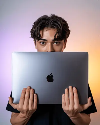 Sticker Mockups Young Man Holding Laptop In Front Of Face With Clean Gradient Background