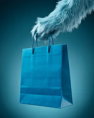 Sticker Mockups Blue Shopping Bag Held By Furry Hand In Minimal Studio With Cool Tone Background