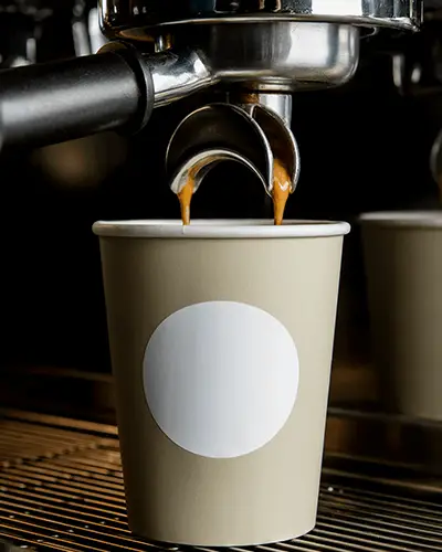Coffee Cup Sticker Mockup Round Label On Paper Cup Under Espresso Machine Barista Scene