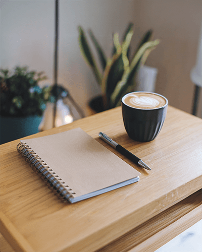 Warm Toned Workspace Sticker Mockup Cozy Desk Setup With Notebook And Cappuccino