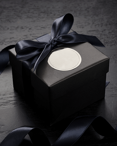 Premium Present Box Sticker Mockup Dark Wrapping With Round Label On Wooden Surface