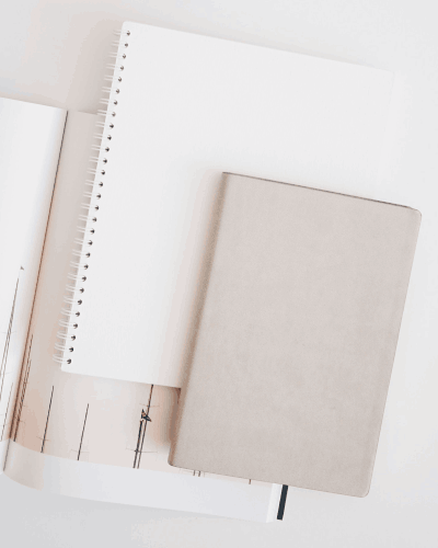 Neutral Notebook Sticker Mockup On Desk With Other Stationery For Sleek Workstation Look