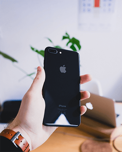 Hand Holding Iphone Sticker Mockup With Blurred Office Background For Realistic Tech Display