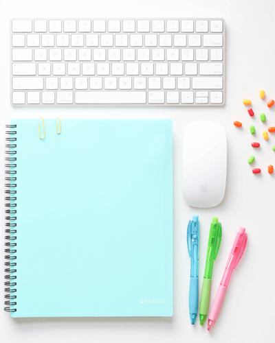 Bright Desk Spiral Notebook Sticker Mockup With Keyboard And Colorful Pens