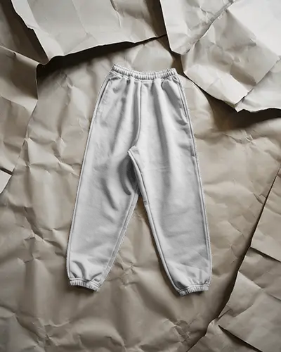 crumpled-paper-background-sweatpant-mockup-minimal-studio-flat-lay-fashion-editorial-style
