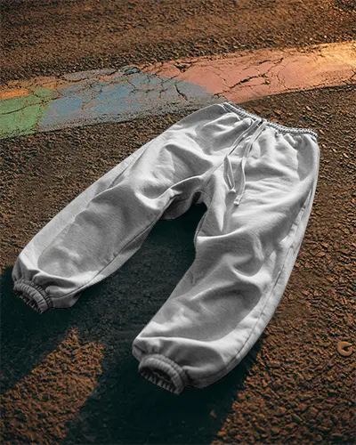 Street Style Sweatpants Mockup Flat Lay On Worn Asphalt With Warm Sunset Light
