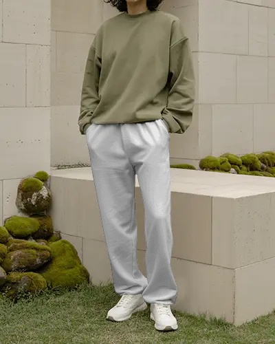 Serene Garden Sweatpants Mockup Relaxed Model Standing By Stone Wall With Soft Moss Detail