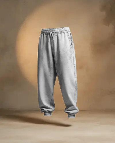 Floating Sweatpant Mockup Against Textured Studio Wall With Soft Dramatic Lighting