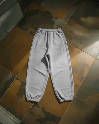flatlay-sweatpant-mockup-on-stone-textured-floor-with-soft-moody-shadows-and-modern-light
