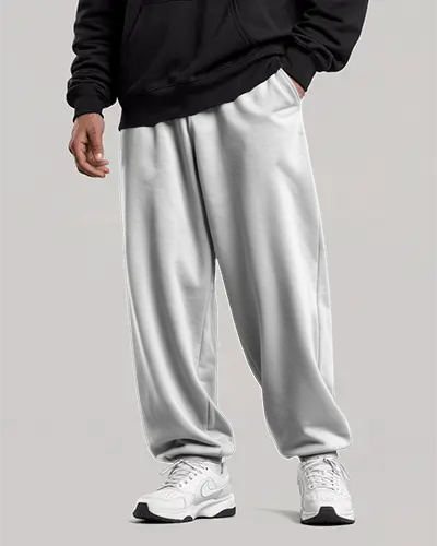 Relaxed Fit Sweatpants Mockup Male Model In White Sneakers On Clean Neutral Backdrop
