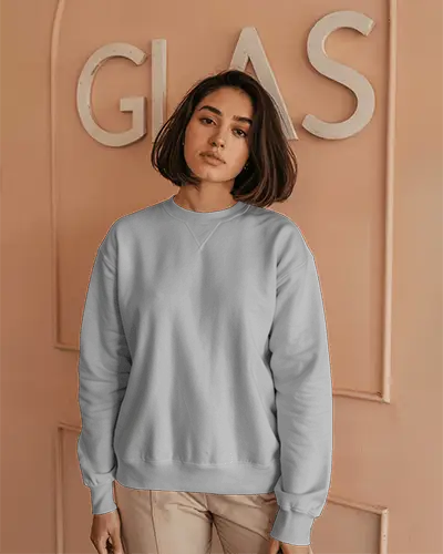 Indoor Sweatshirt Mockup Female Model In Light Grey Crewneck Against Peach Wall With Glass Sign Soft And Modern Aesthetic