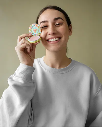 smiling-female-model-white-sweatshirt-mockup-holding-colorful-cosmetic-product-closeup-front-view-for-design-showcase