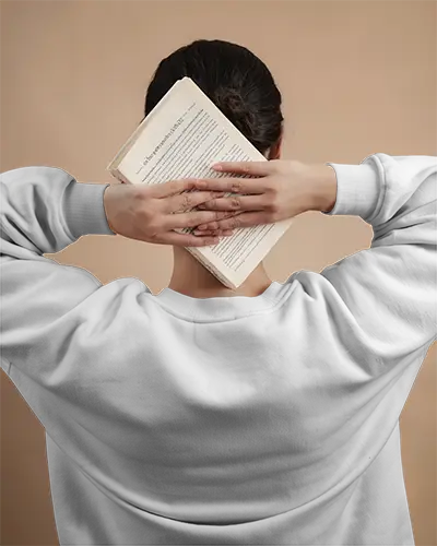 back-view-white-sweatshirt-mockup-female-model-holding-book-overhead-minimalist-scene-with-neutral-background