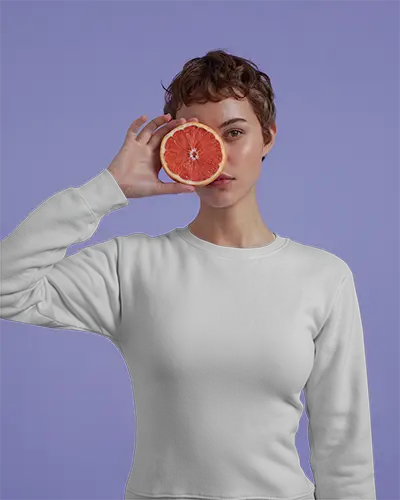 playful-white-sweatshirt-mockup-female-model-holding-grapefruit-against-purple-background-bold-and-modern-style