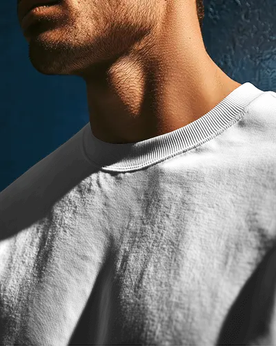 closeup-sweatshirt-mockup-male-model-neckline-in-dramatic-shadow-light-blue-backdrop