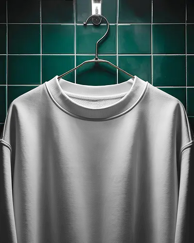 hanging-sweatshirt-mockup-in-dark-moody-bathroom-setting-with-tiled-green-wall-backdrop