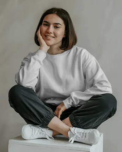 Cozy Lounge Sweatshirt Mockup Female Model Sitting Cross Legged In Studio With Soft Smile
