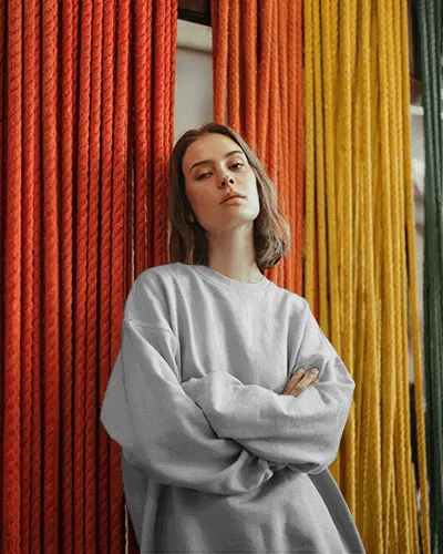 Urban Editorial Sweatshirt Mockup Female Model Standing Against Red And Yellow Rope Backdrop