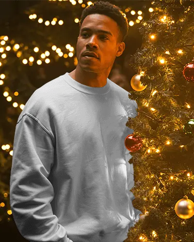 Christmas Sweatshirt Mockup Male Model Standing By Tree With Golden Lights And Baubles