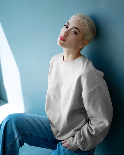 Relaxed Sweatshirt Mockup Female Model In Denim Sitting Against Blue Wall Modern Style