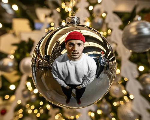 Creative Christmas Sweatshirt Mockup Man Reflected In Bauble With Tree Lights