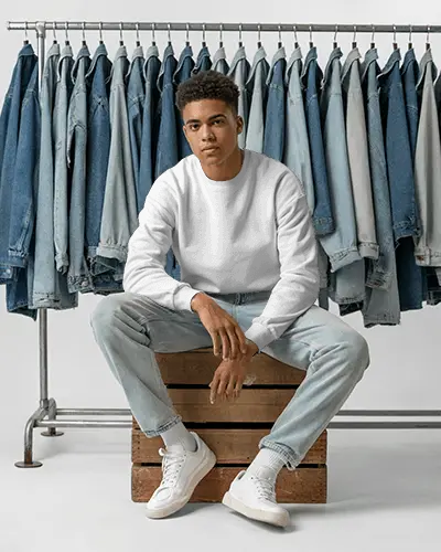 Casual Comfy Unisex Sweatshirt Mockup Model Sitting Front Denim Jackets On Rack Photography