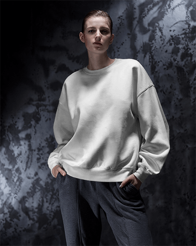 Moody Dark Sweatshirt Mockup Female Model With Casual Pose Against Industrial Background